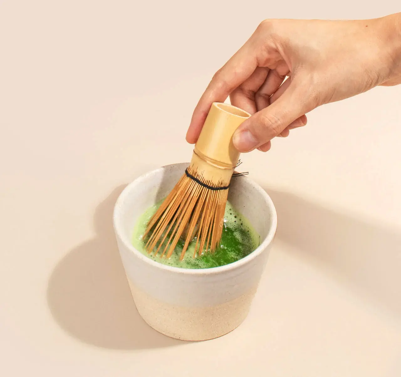 A bamboo whisk and bowl arranged for a Yuyi matcha ritual
